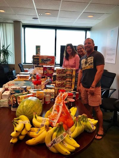postirma3.jpg Volunteers at table with food donation supplies