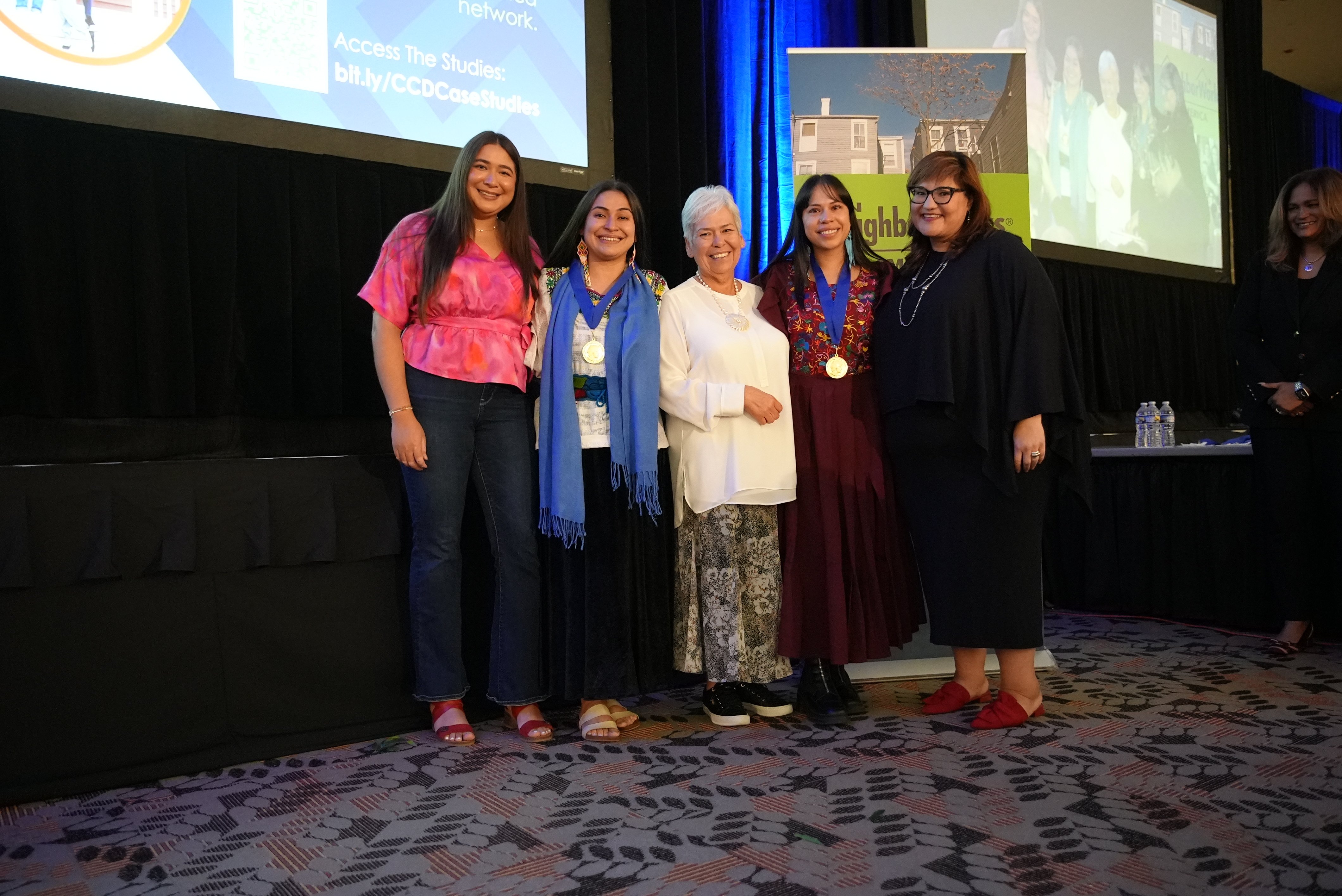 Niria and Alicia with their families and Marietta Rodriguez.
