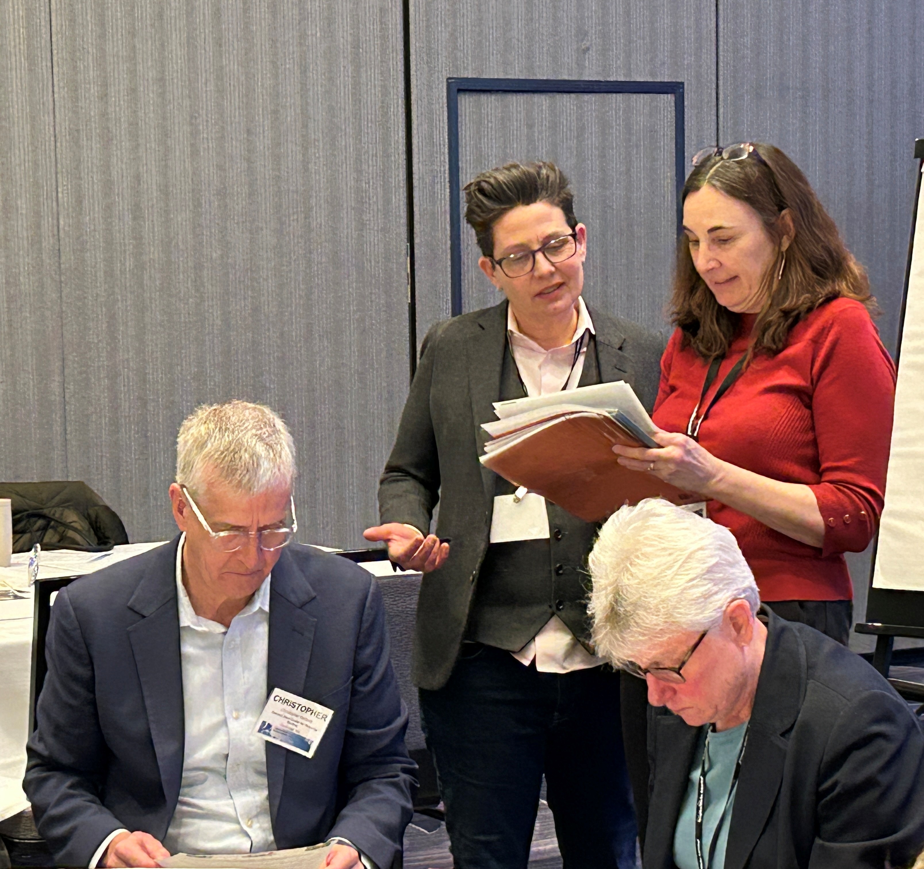 Kate de la Garza talks with NeighborWorks staff during a breakout session.