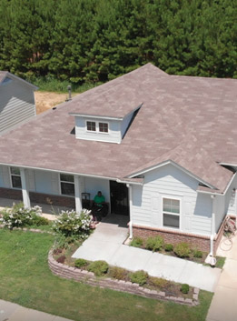 A house is nestled in the middle of a heavily wooded area