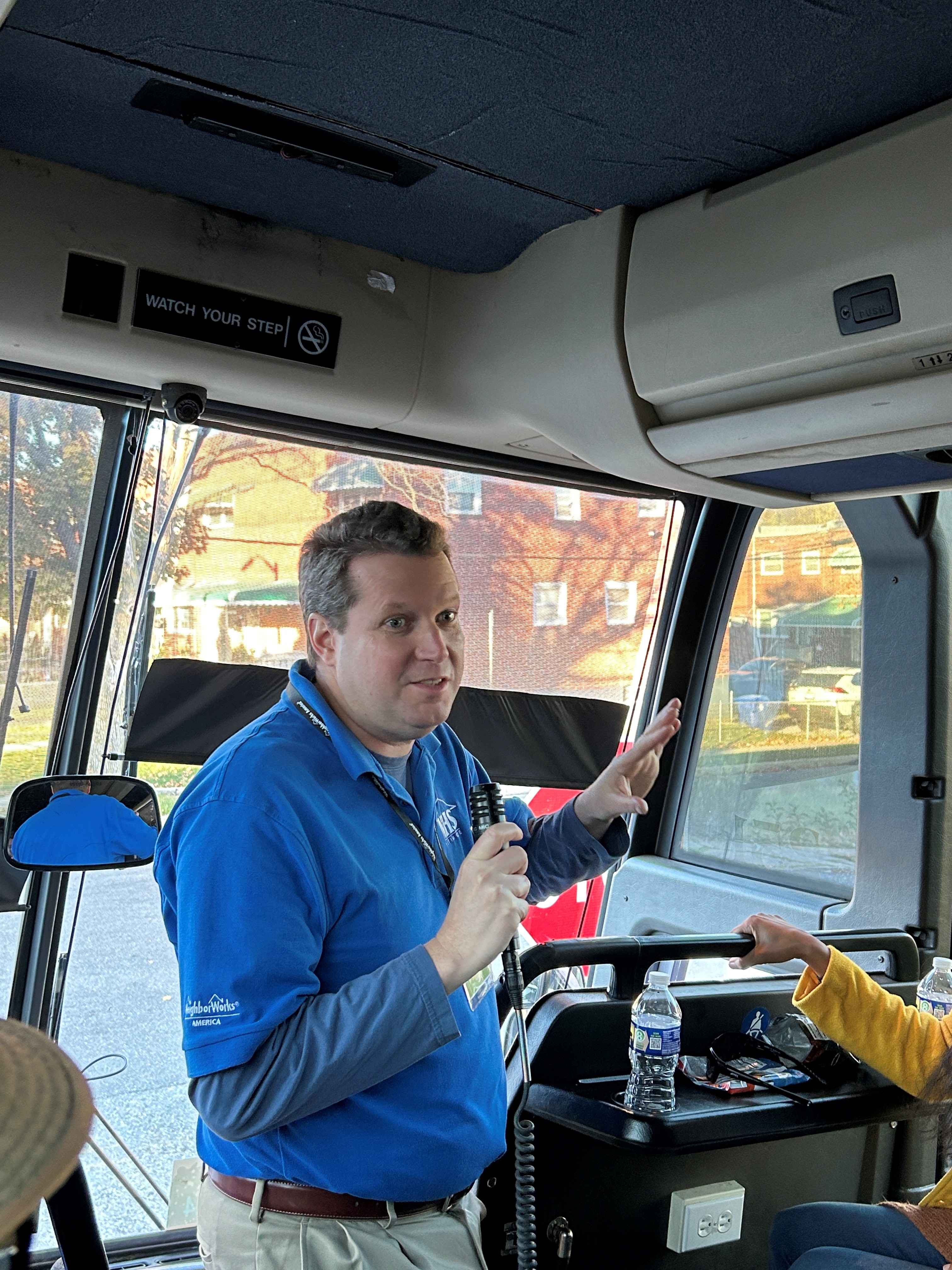 Dan Ellis talks on a bus tour of West Baltimore