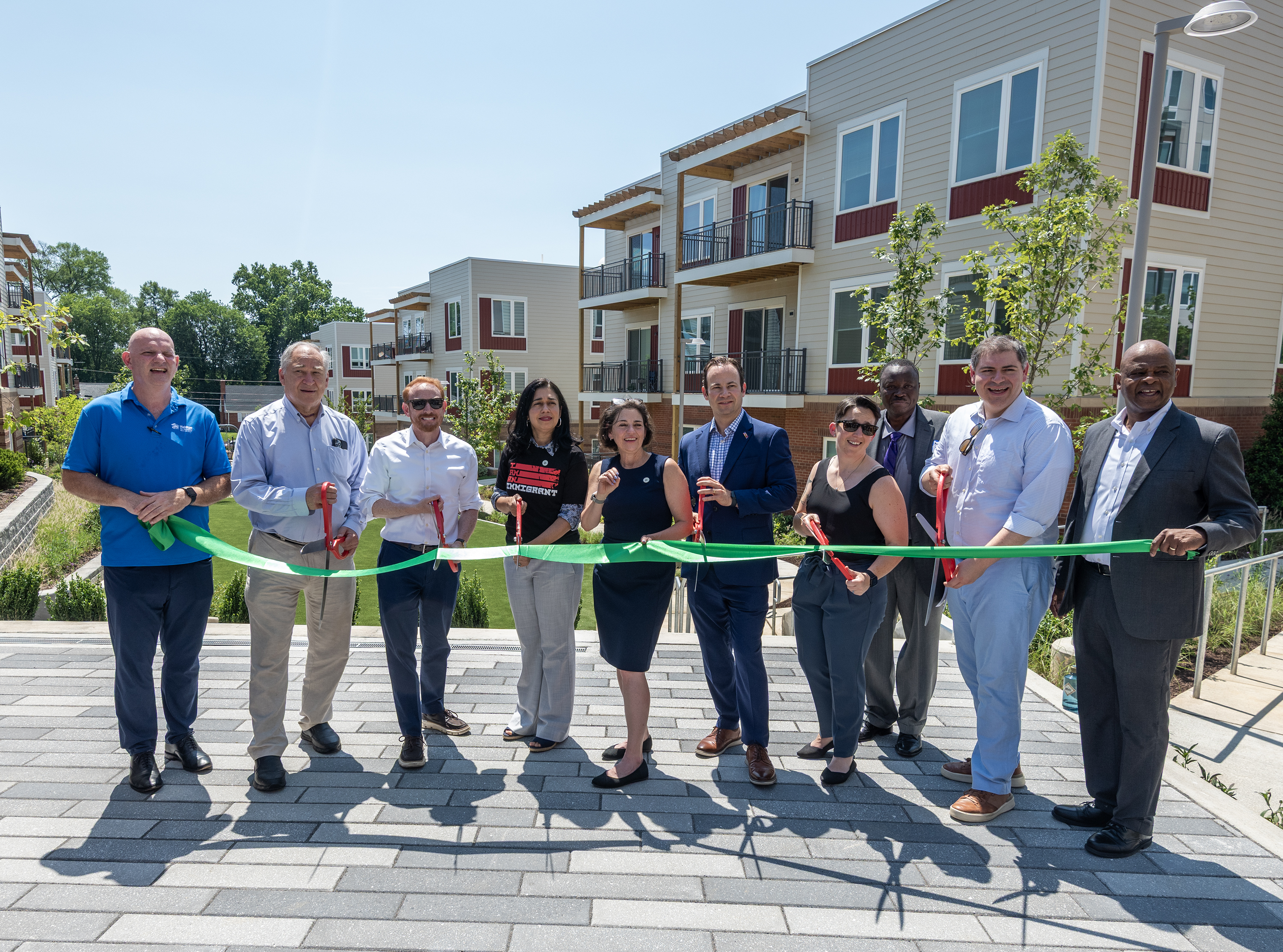 The crew cutting the ribbon at Allium Place