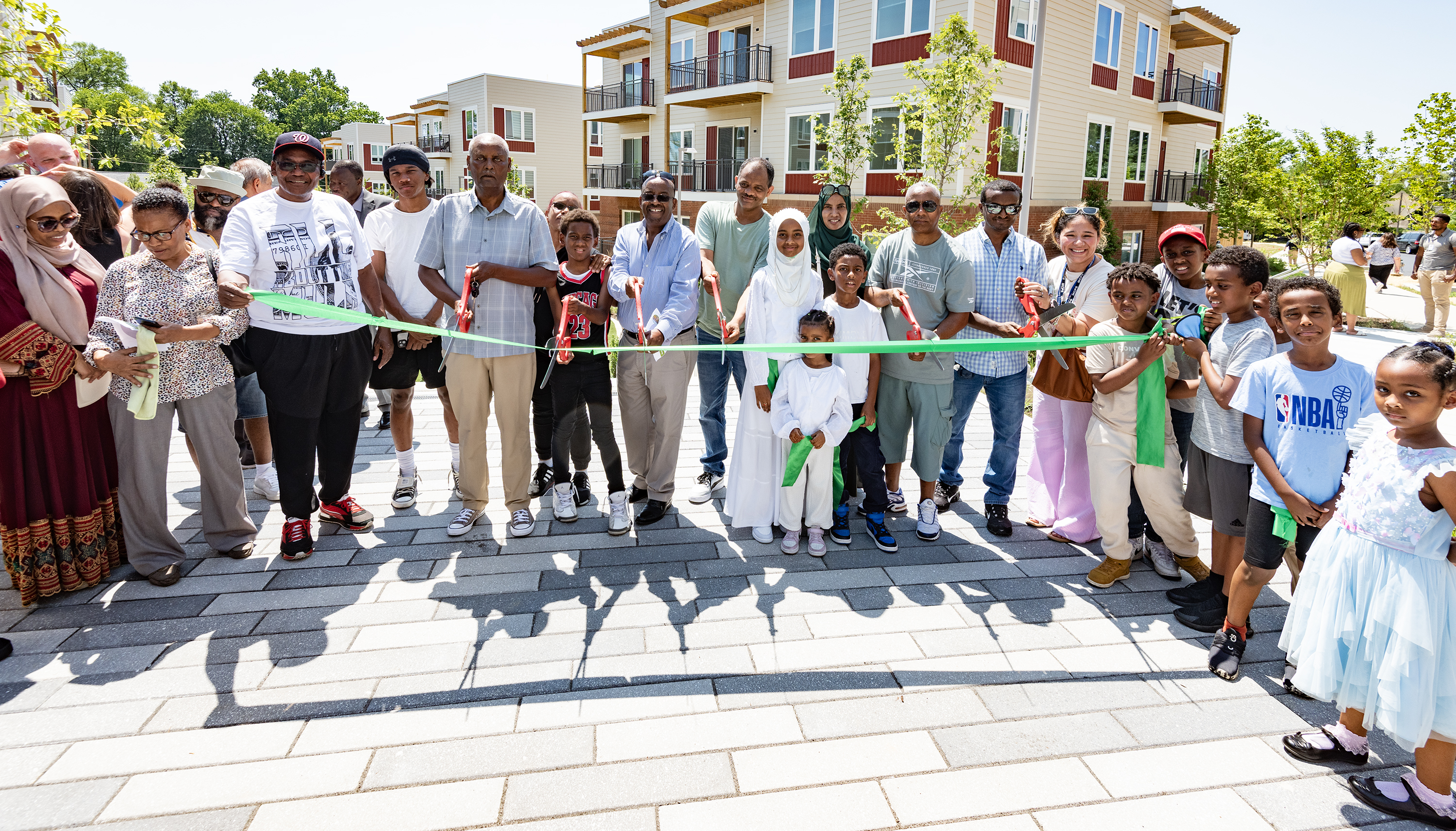 A combination of residents joins in the ribbon cutting.