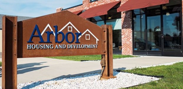 A sign marking Arbor Housing and Development.