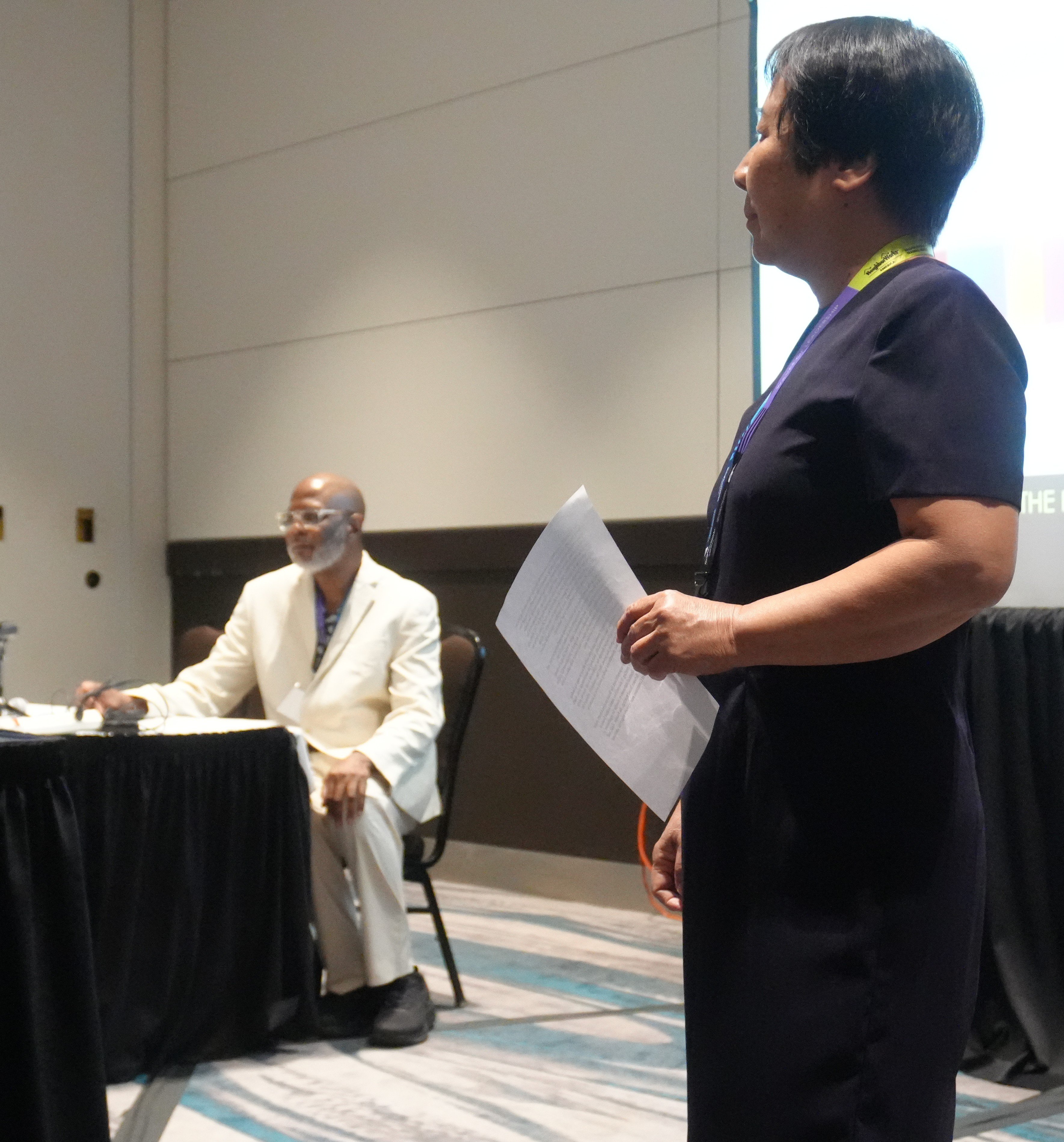 Sue Chen from NeighborWorks talks about Board Governance as Melford Ferguson listens.