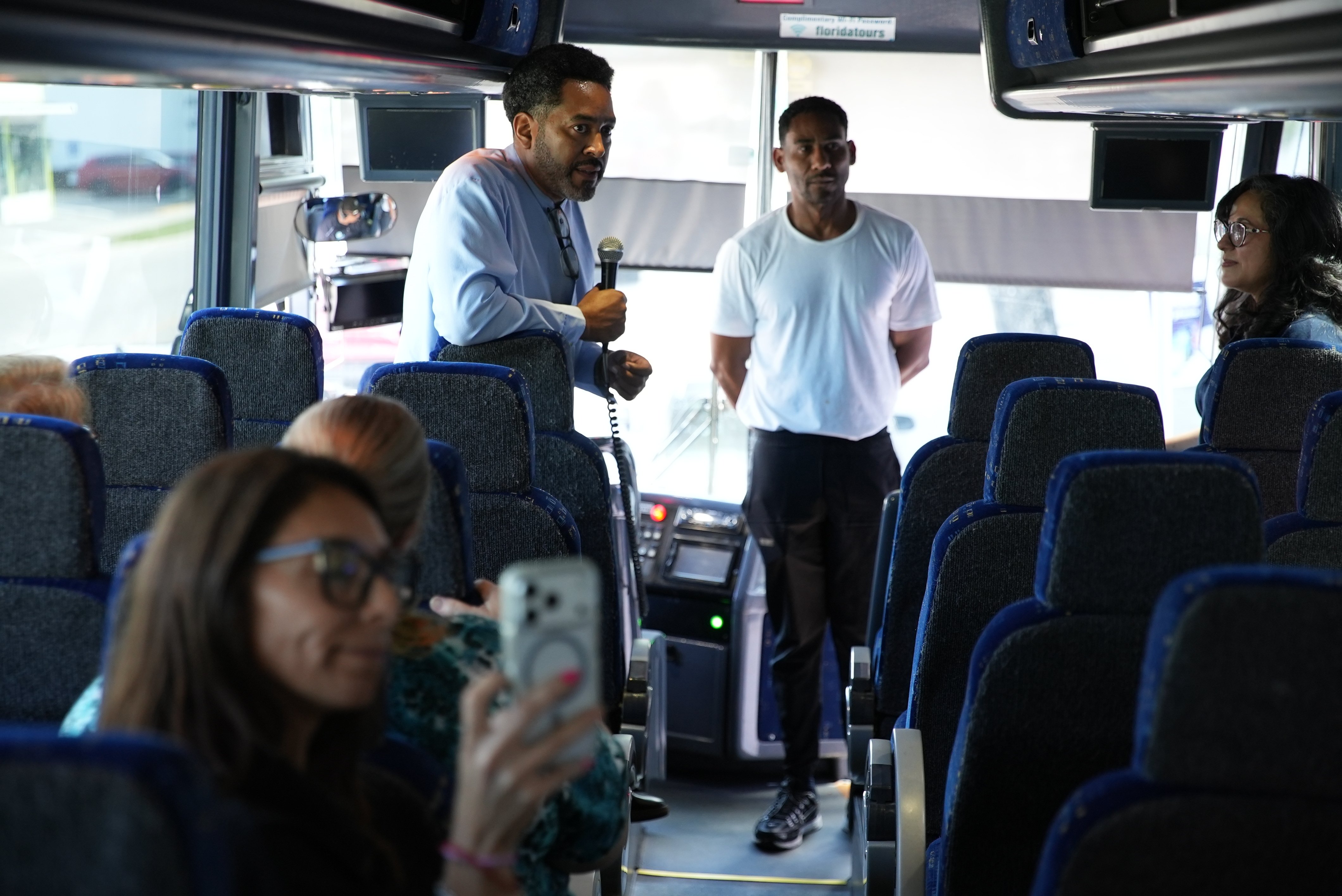 Omar talks about his barbershop during a bus tour.