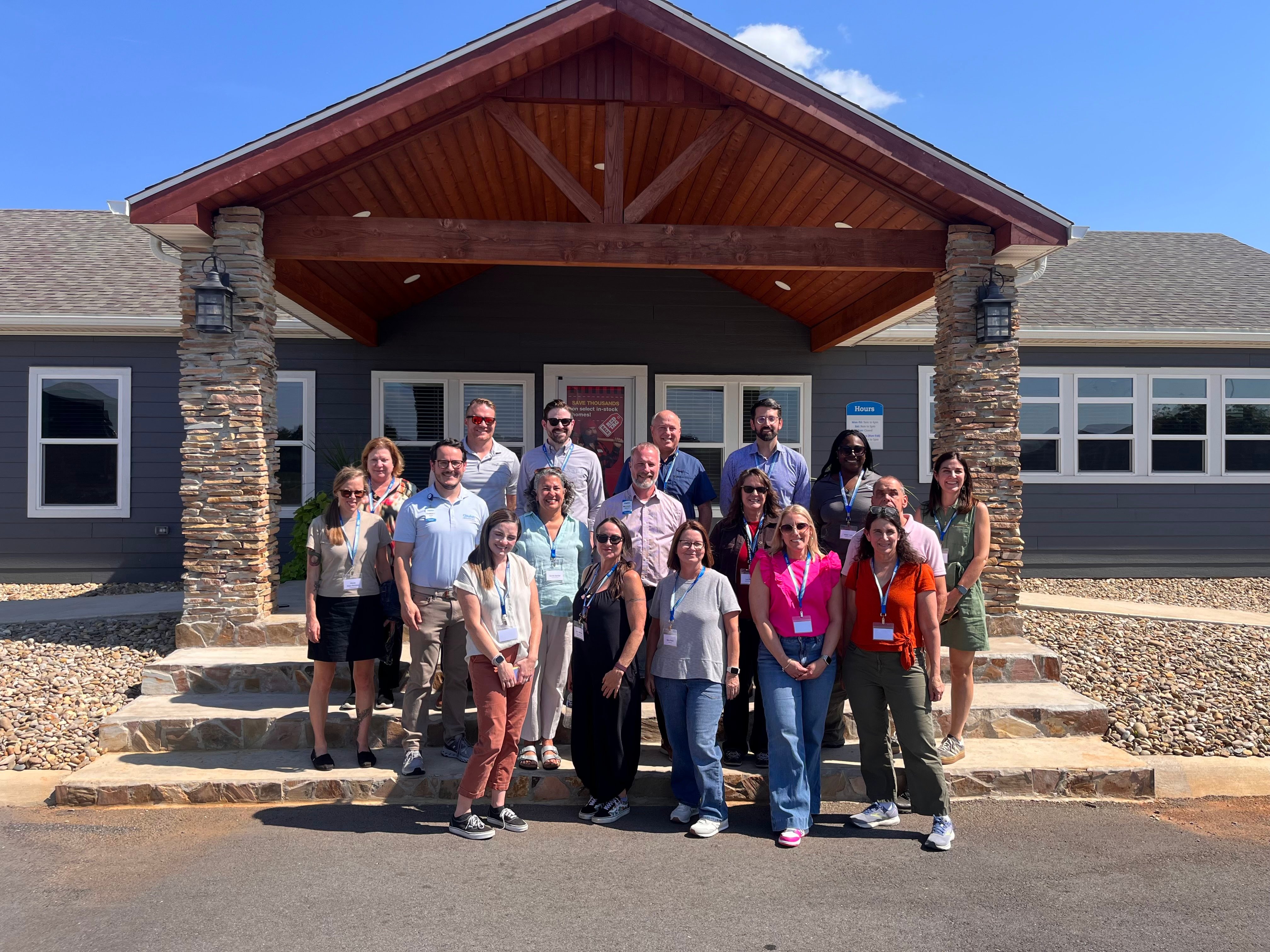 Touring group gathers at a Clayton sales spot to learn more about the different opportunities available.