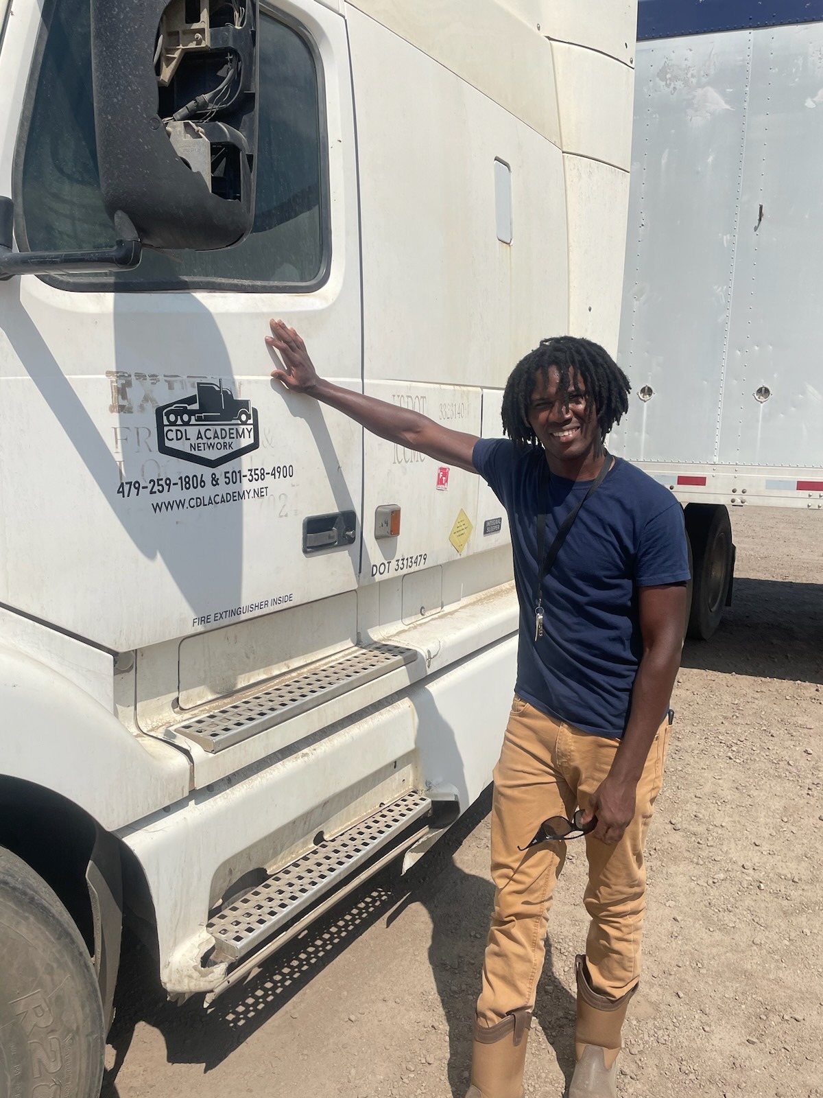 Melvin stands beside his truck