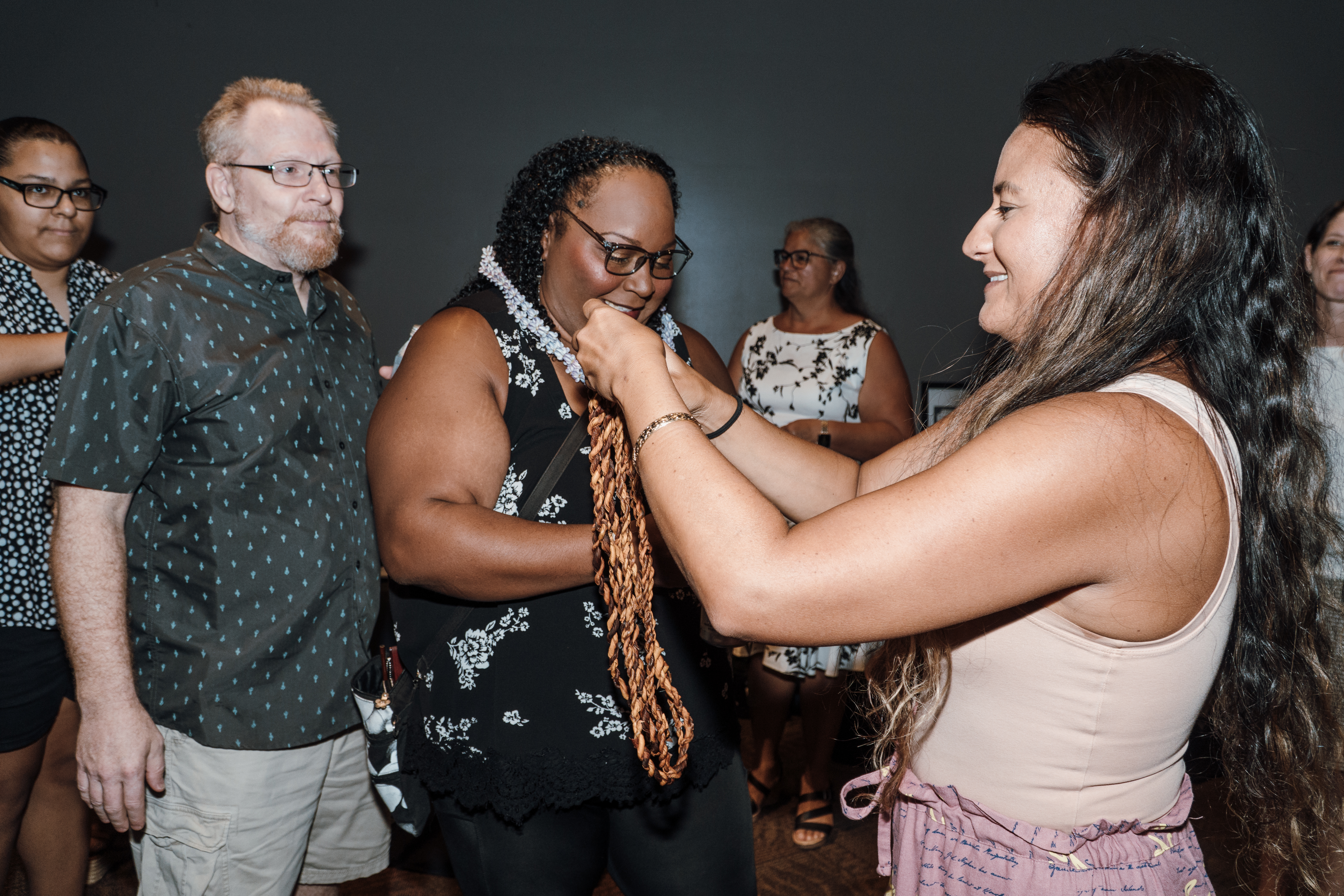 Makana Reilly, Director of Advancement and Communications at Hawaiian Community Assets (HCA), welcomes Tiffany Jackson and her family on Aug. 11, 2025, at the ʻImiloa Astronomy Center in Hilo. Jackson is the first HCA client to own her home through the organization’s pioneering Ua Hale Aʻela program. Photos by Cody-Fay Alameda