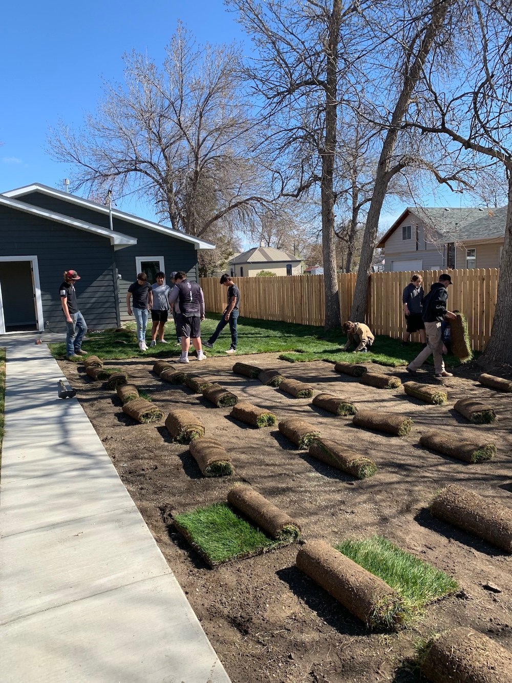 Students work on the yard of the high school home.