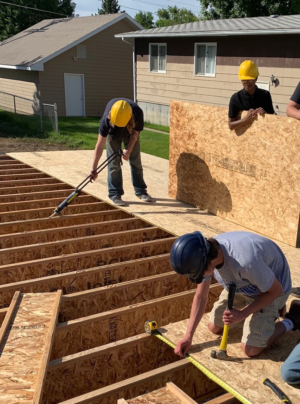 Students work on a house in Great Falls, Montana.