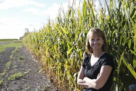 Marcia Erickson against a backdrop of corn.