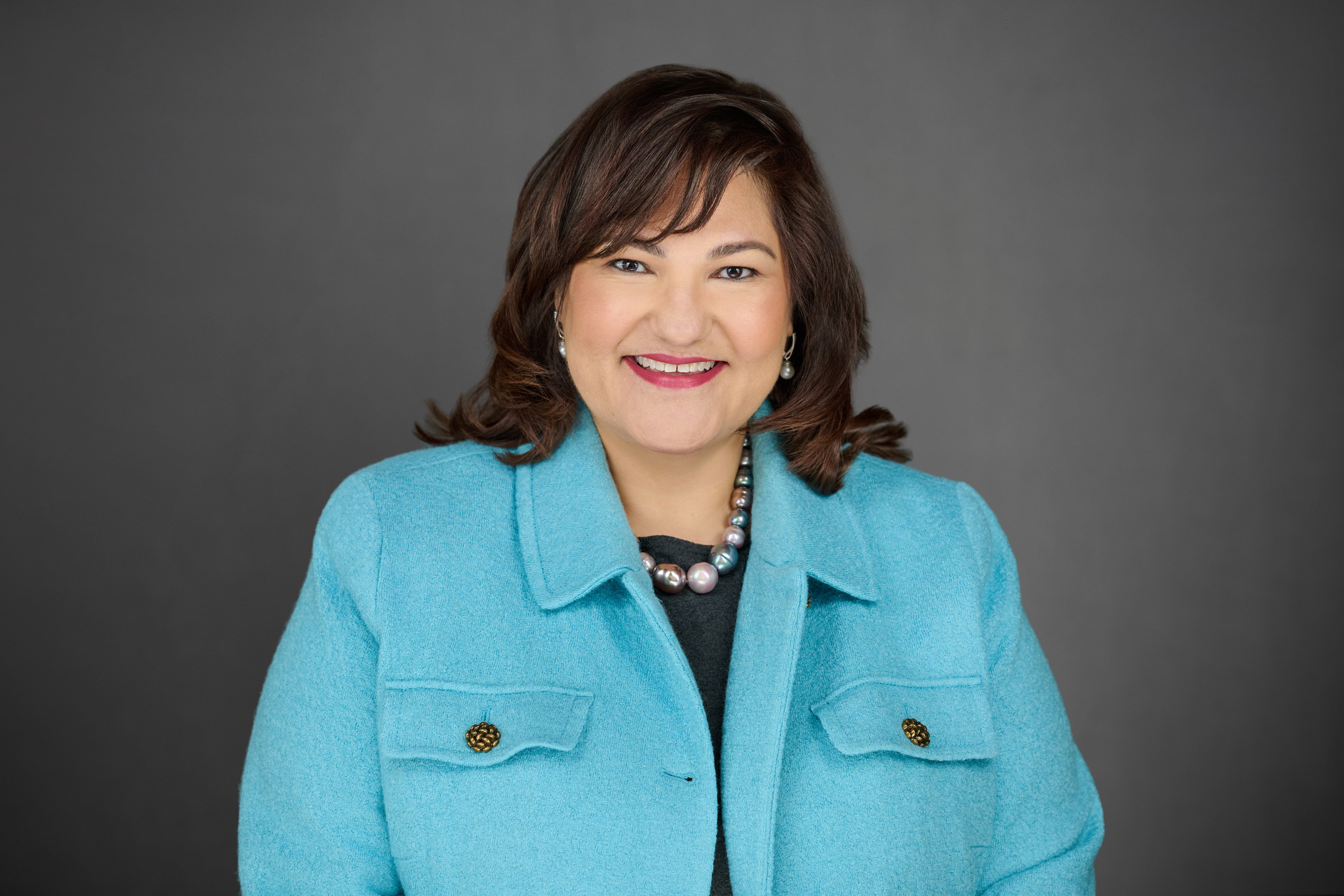 Marietta Rodriguez of NeighborWorks America against a gray background.