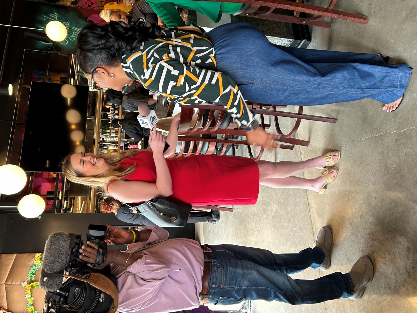 A camera person interviews staff of NHS of Balitmore