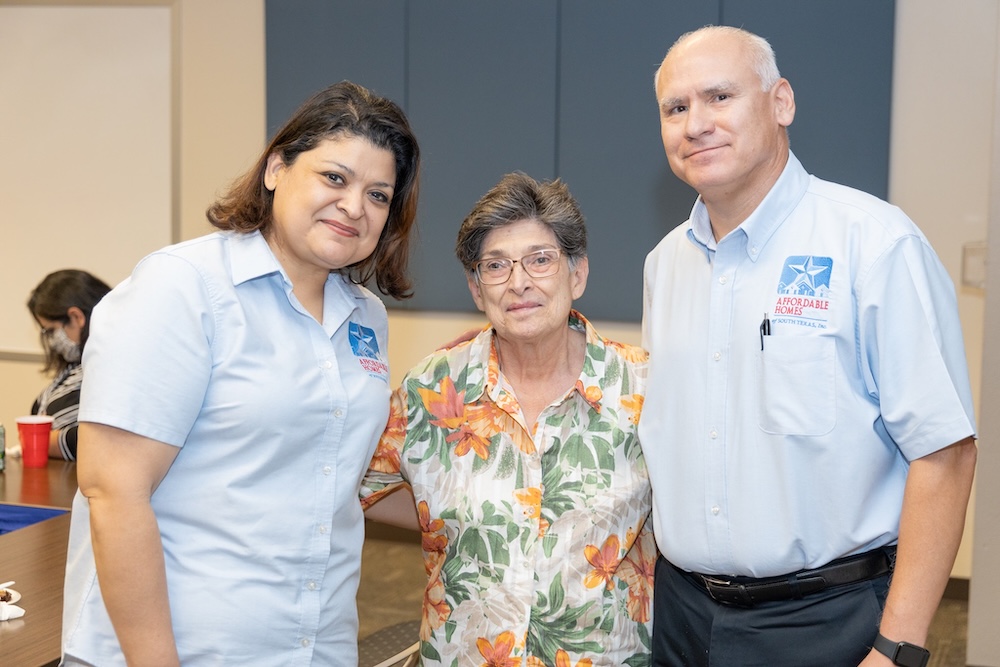 Robert and Myra stand with a resident.