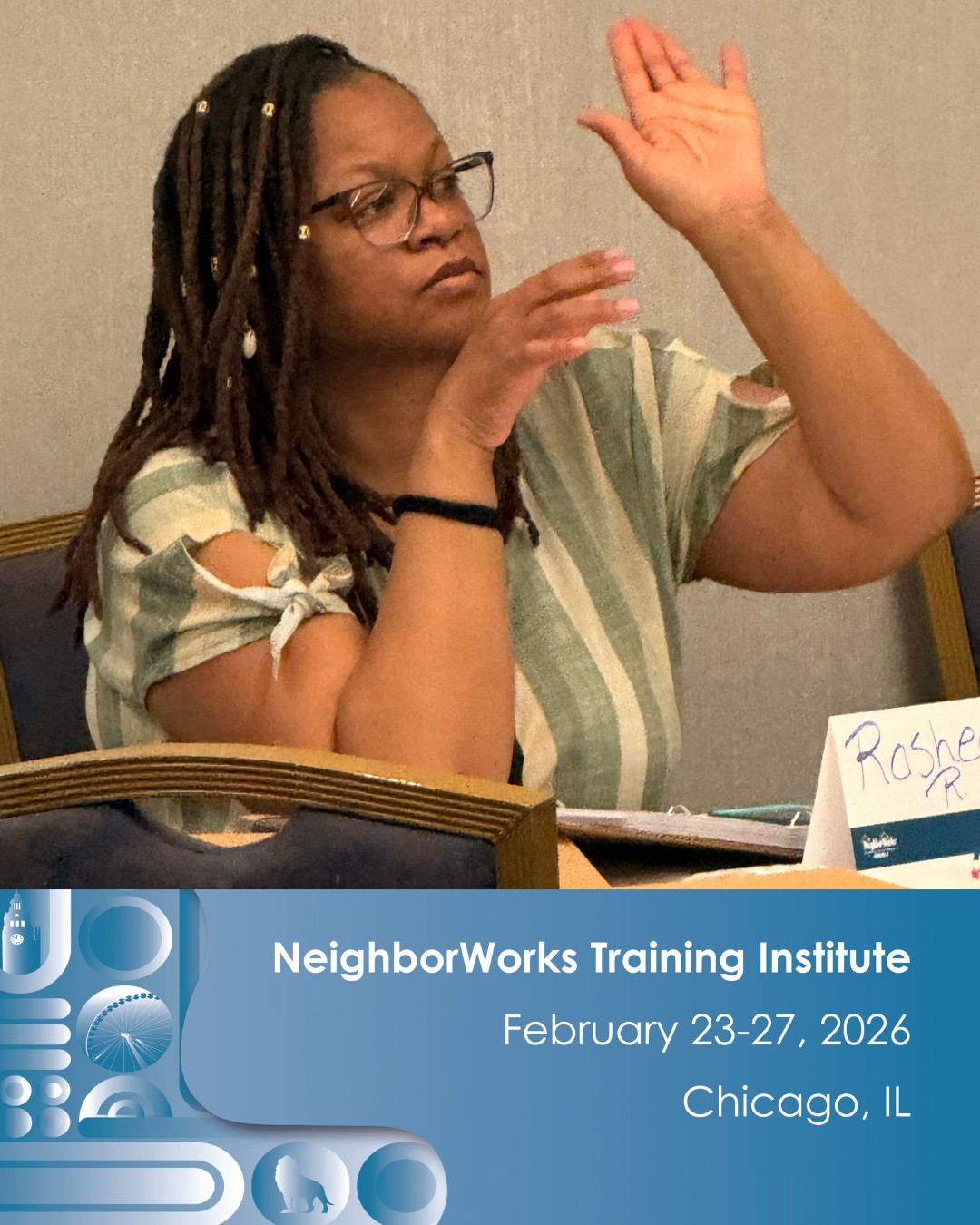 A woman raises her hand in class during a training.