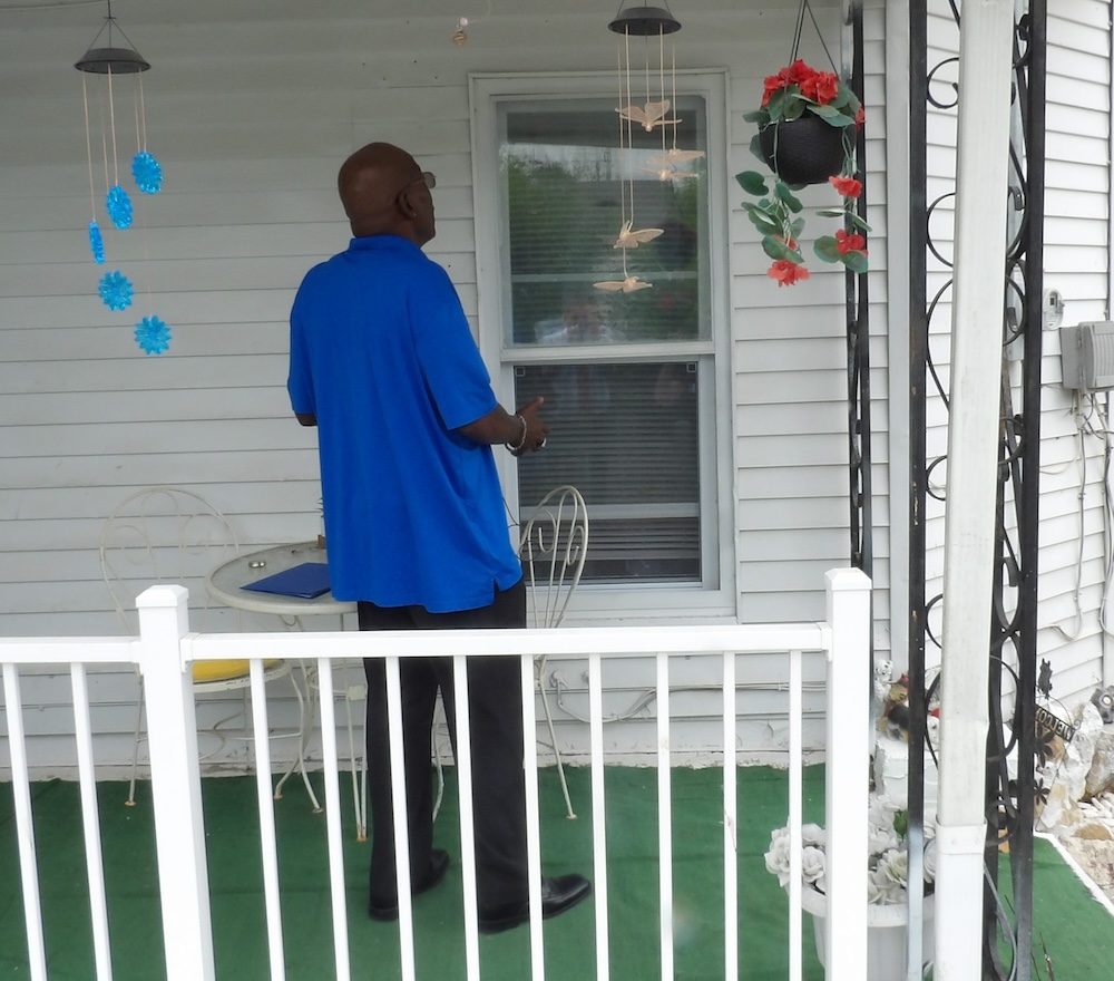 Kenneth Hemphill inspects the work he did on his home in Hannibal, Missouri.