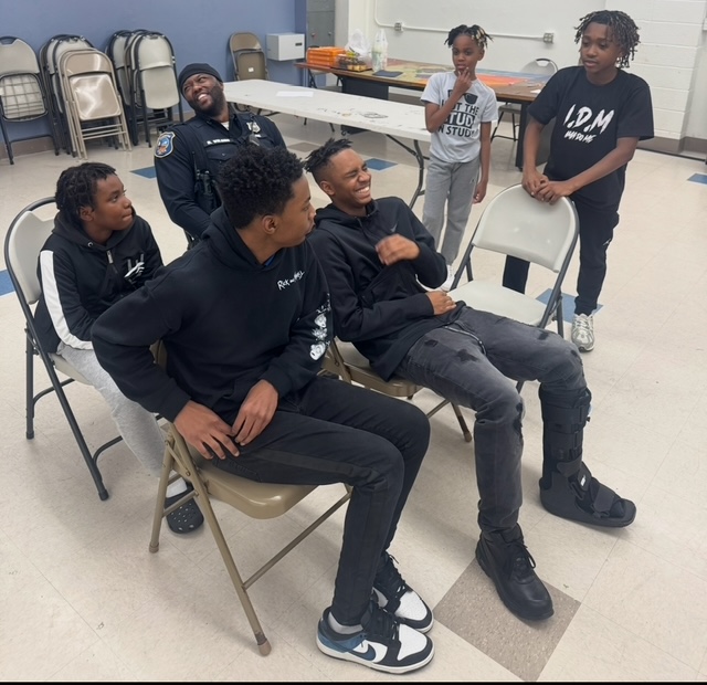 Students share a moment of laughter with Corp. Wilson.