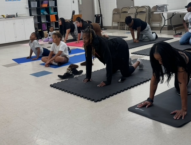 Youth do yoga together in part of the program at ICHD