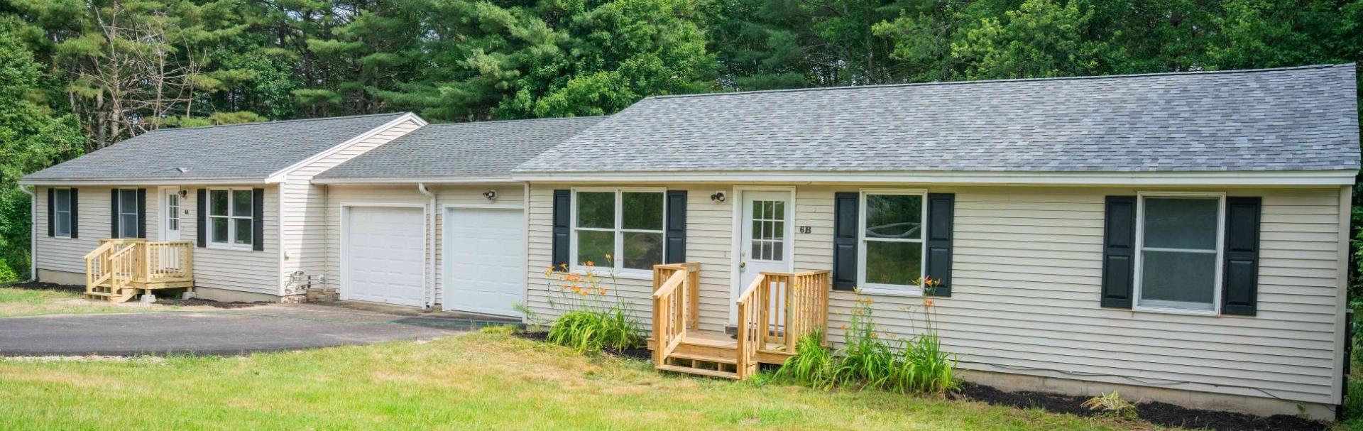New homes in Maine, with a shared garage and shutters.