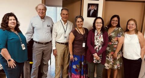 Before a meeting in Guam, people stand together, including Steve Barbier.