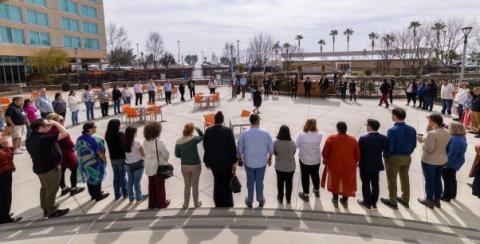 A group stands in a circle at the Native Partnership Gathering
