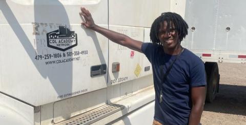 Melvin stands beside his truck.