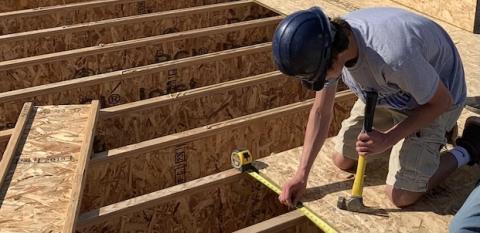 A student works on a house in Great Falls, Montana