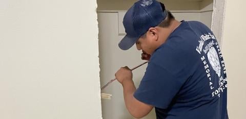 An intern works on a home. 