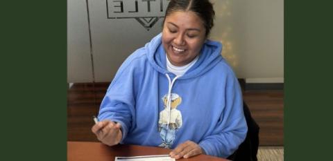 Elizabeth at her closing with a pen in her hand.