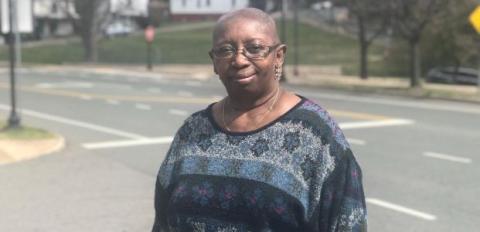 Carmelita in a sweater in her neighborhood.